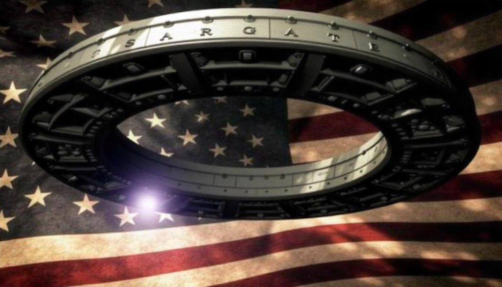  A circular stargate structure with the word "Stargate" visible at the top, surrounded by a dark, textured background that features elements of an American flag. The flag's colors of red, white, and blue are prominent, with stars and stripes blending into the design. The stargate appears illuminated with a soft glow, creating a sense of depth and intrigue.